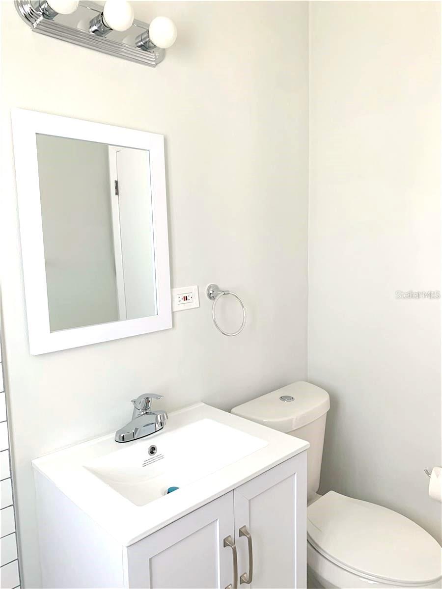 New toliet, cabinet and light fixtures