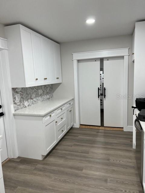 Kitchen with barn doors into laundry room