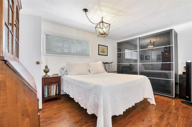 The large master has a half bath, and a beautiful chandalier