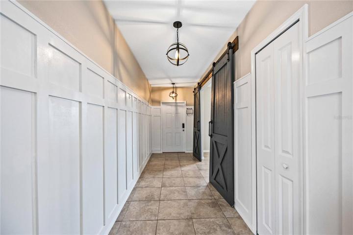 Hallway with barn doors into den