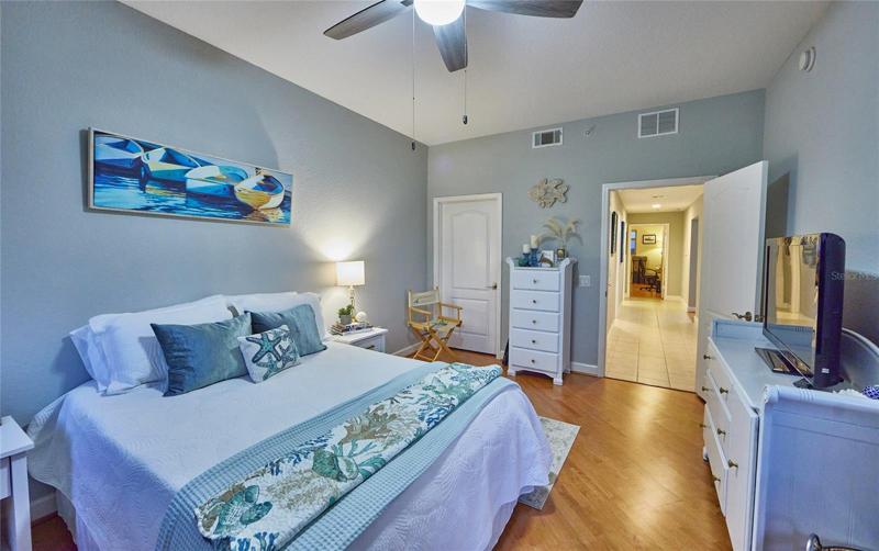 Guest room with balcony entrance and walk in closet.