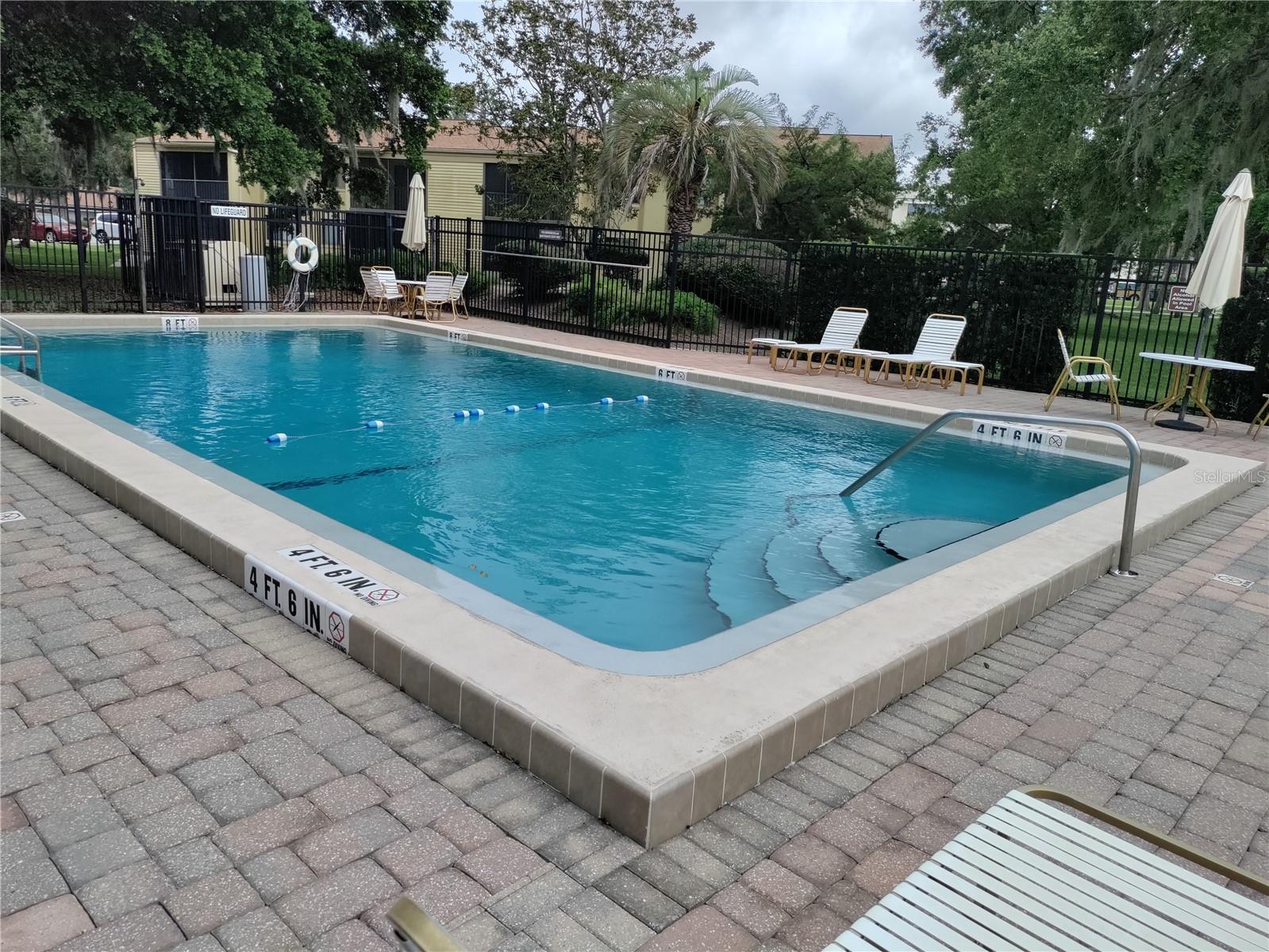 Huge well-maintained community pool is right outside your front door.