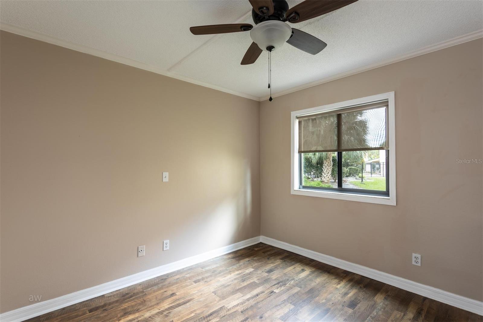 Second bedroom, view of community pool.