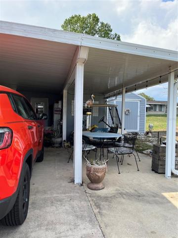 Carport & Sitting area. Large Shed