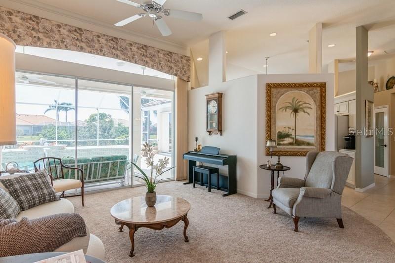 living room with sliding glass doors to pool area