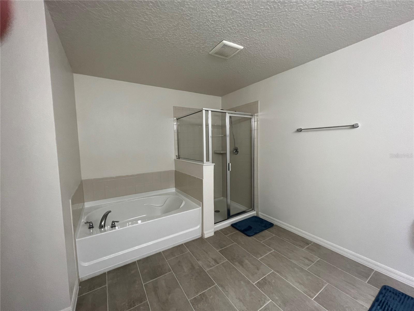 Master Bathroom with soaking tub and shower