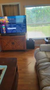 Door behind TV that leads out into back yard.