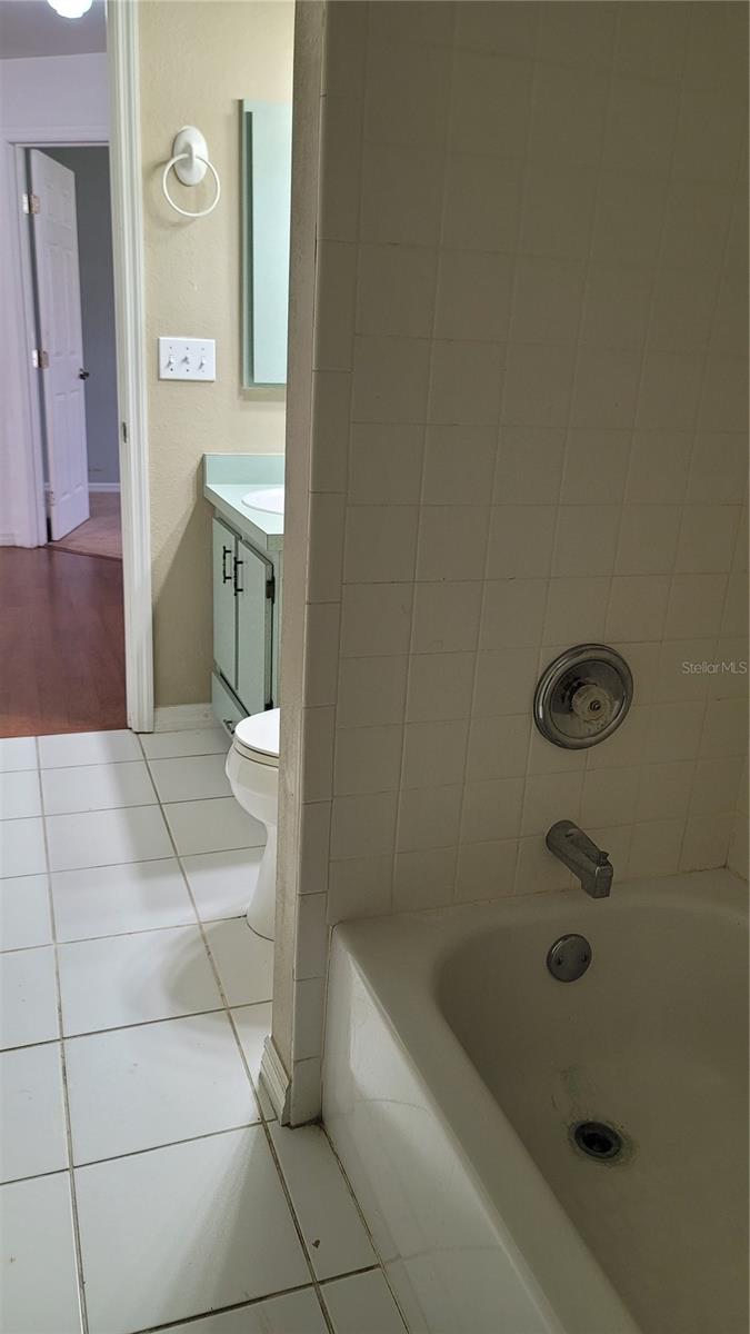 guest bathroom with tub shower combo