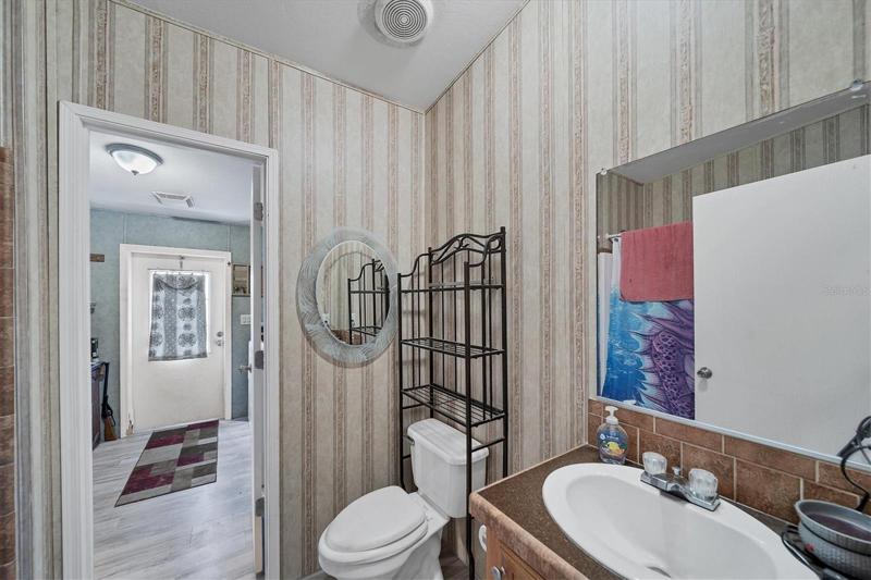 Pseudo JacknJill bath opens to laundry room and hallway to other 3 bedrooms; no tracking dirt throughout house