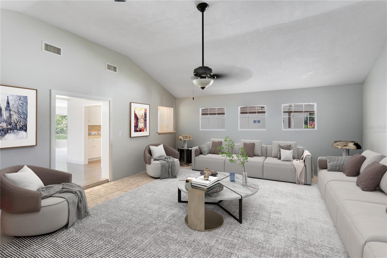 This photo is virtually staged. Vaulted ceilings in the great room offer up a light and airy feel.