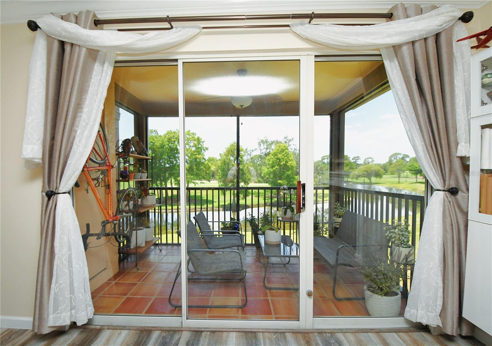 Updated screened-in patio with an amazing view of the Gulf Course and a pond with water flowing through a variety of hills with walkways and connecting bridges that are part of the local Feather Sound Country Club.