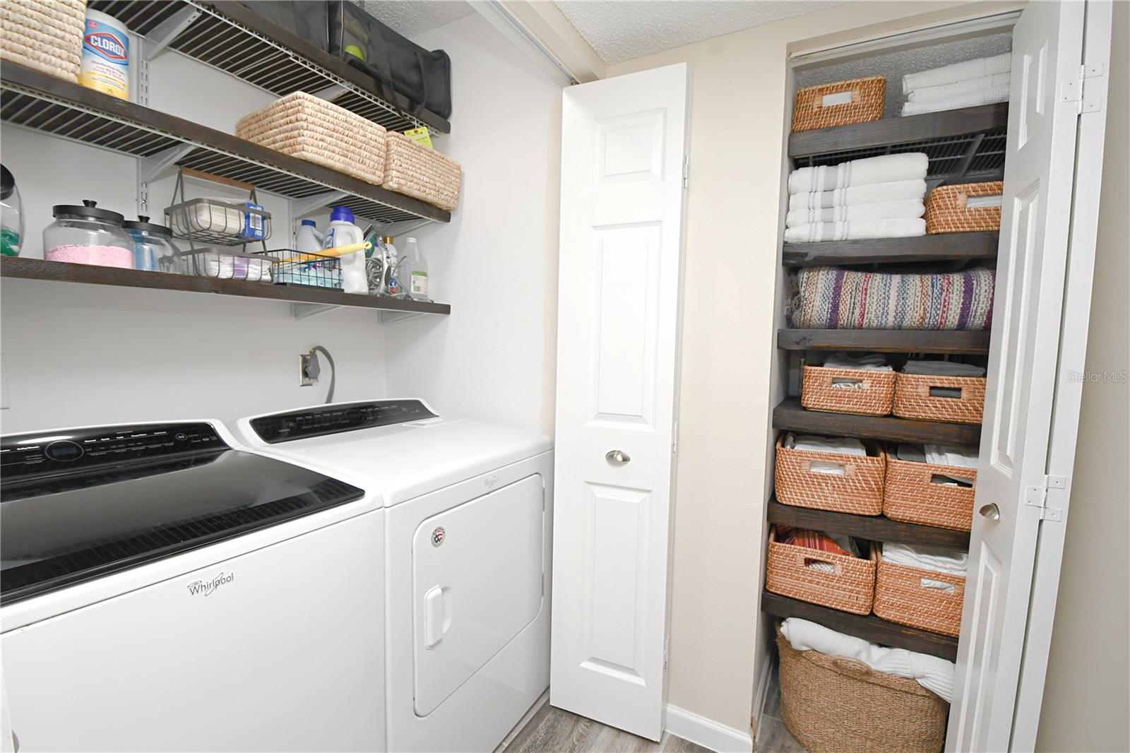 Laundry closet with built-in shelves - washer and dryer stay. Linen closet in a hallway.