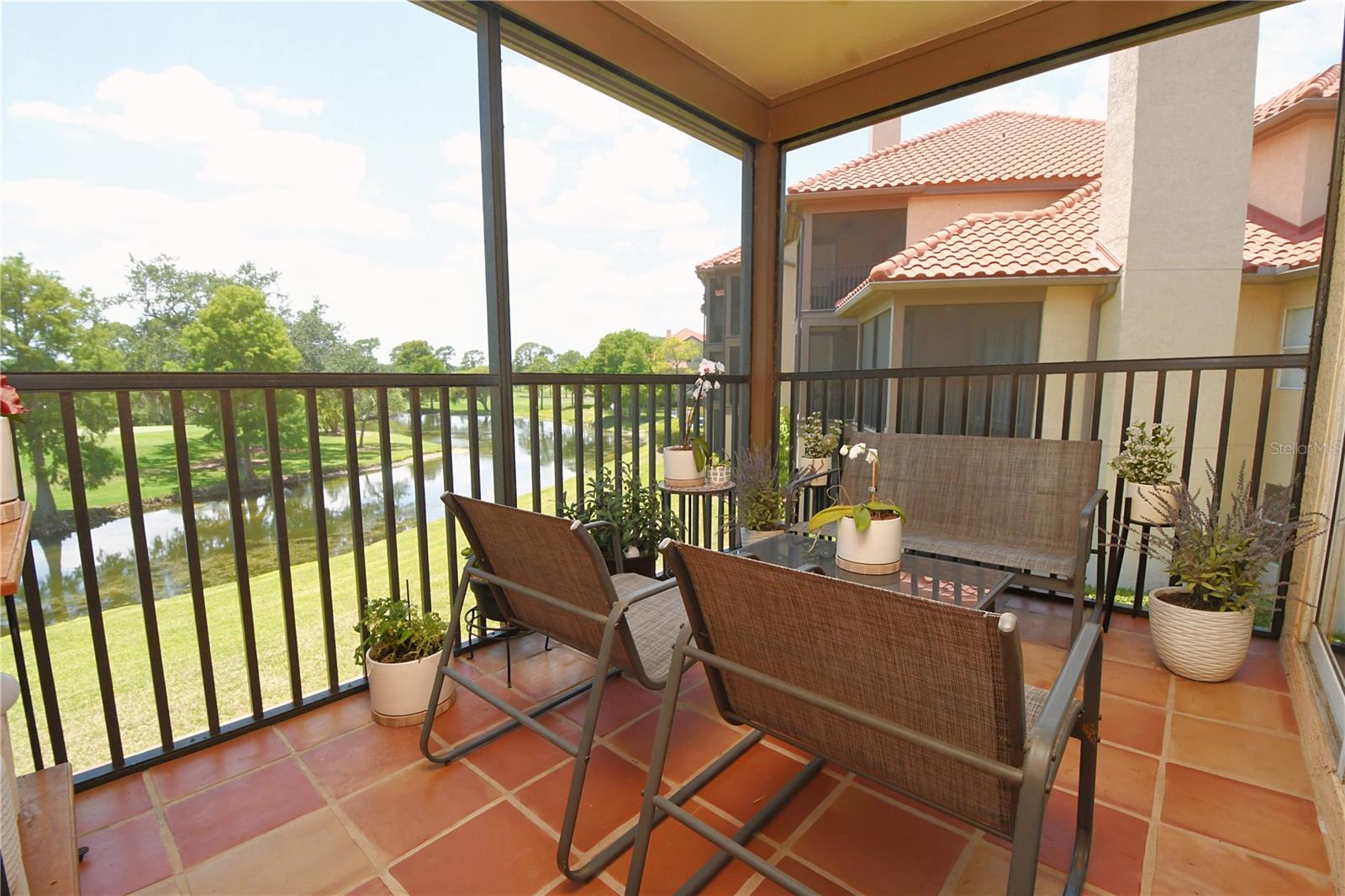 Screened-in porch/balcony that overlooks a beautiful gulf course and a pond.