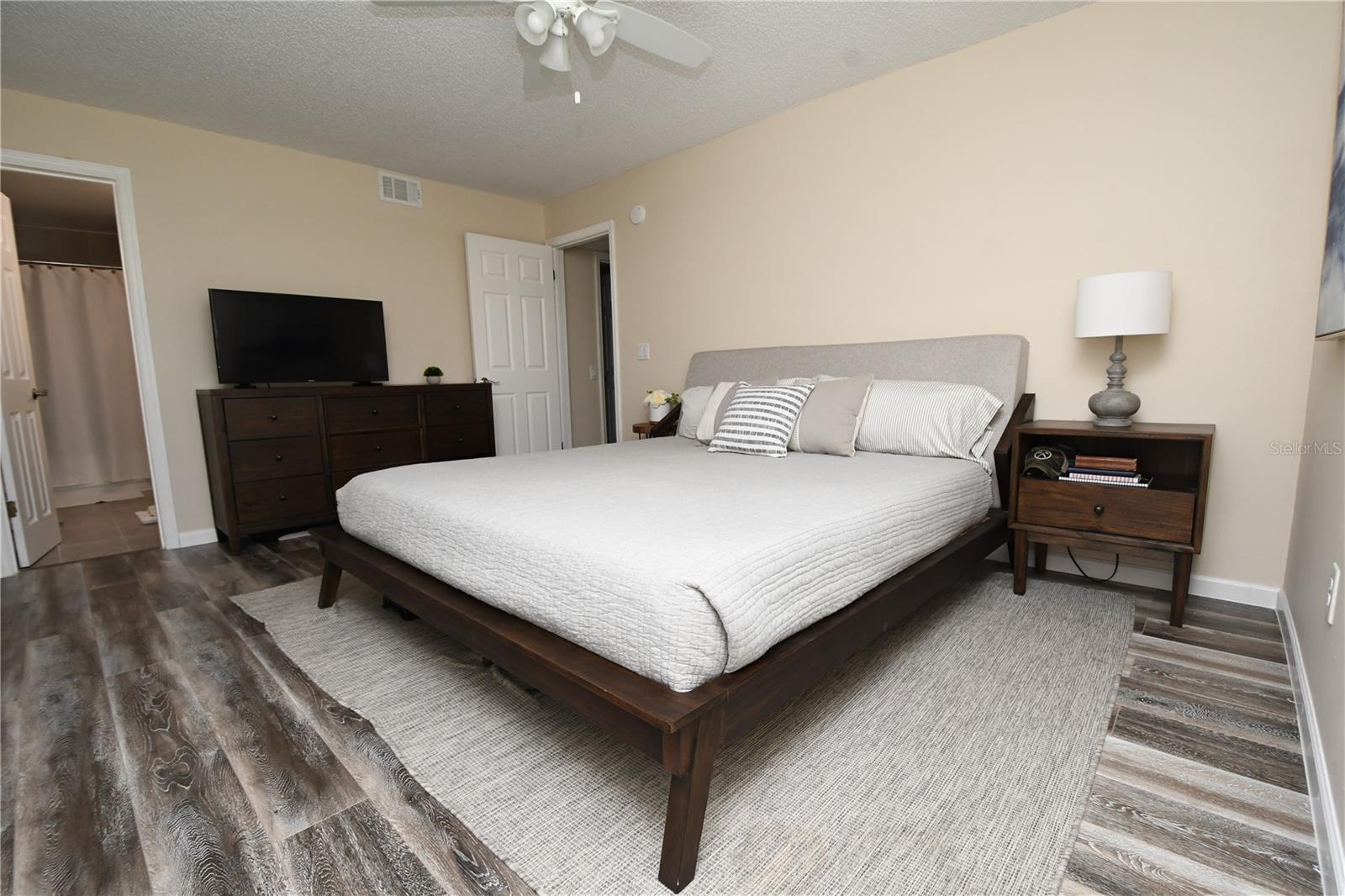 Master bedroom with en-suite bathroom. Luxury vinyl flooring and ceiling fan/light.