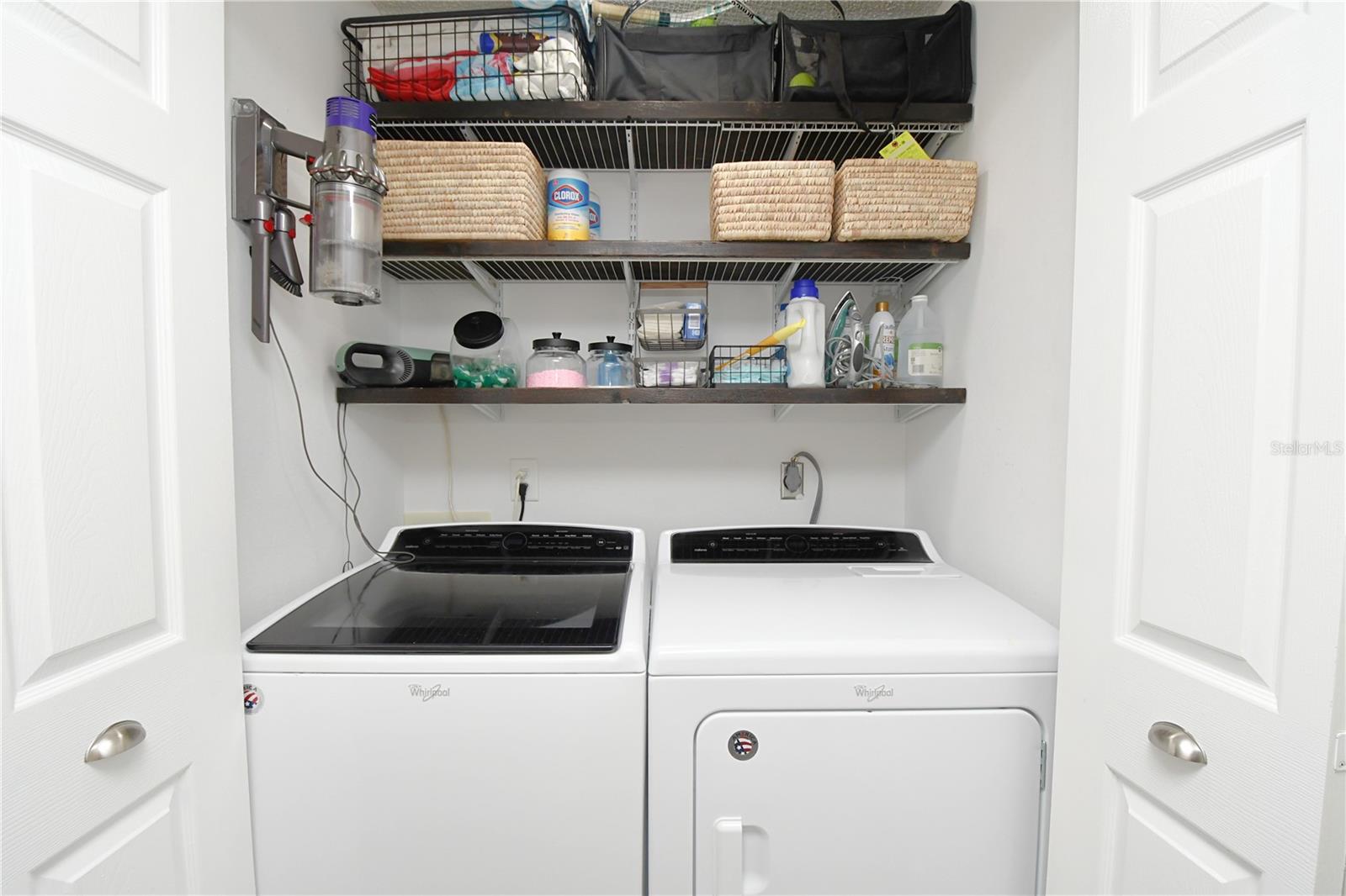 Laundry closet with built-in shelves - washer and dryer stay.