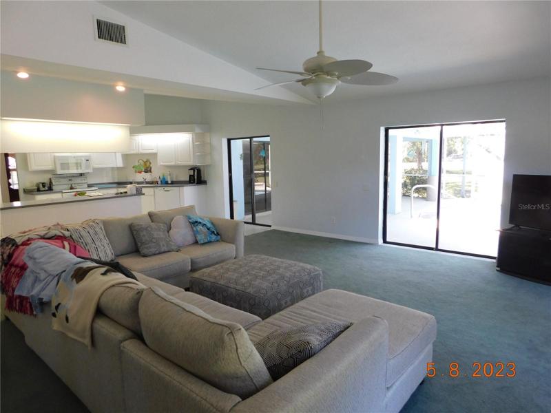 family room opens to the kitchen and expansive lanai & pool