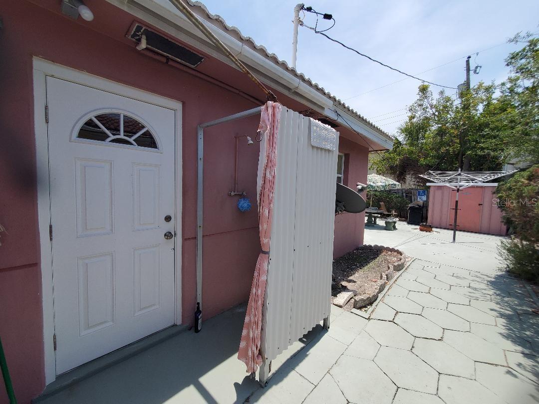Outdoor shower, side door to garge