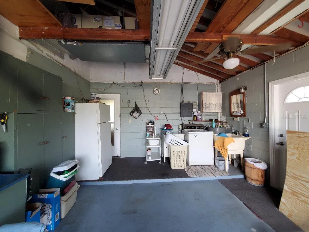 Garage with laundry platform and wet sink.