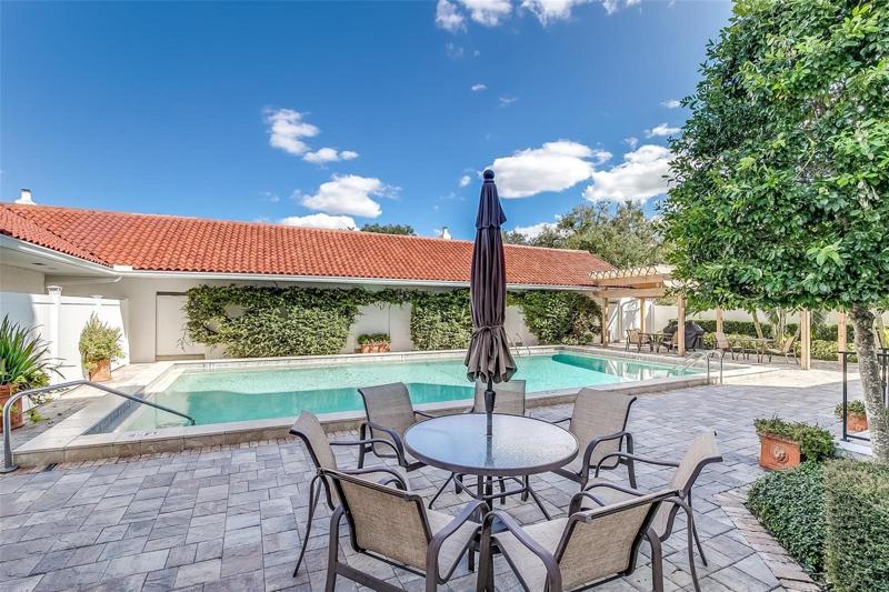 Community pool with seating/lounge areas.