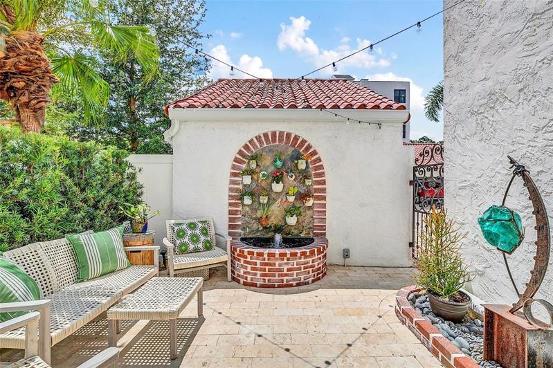 Private, enclosed patio with a fountain.