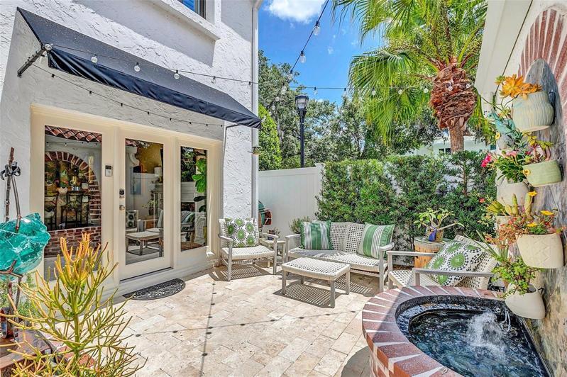 Charming rear patio with an entrance gate.
