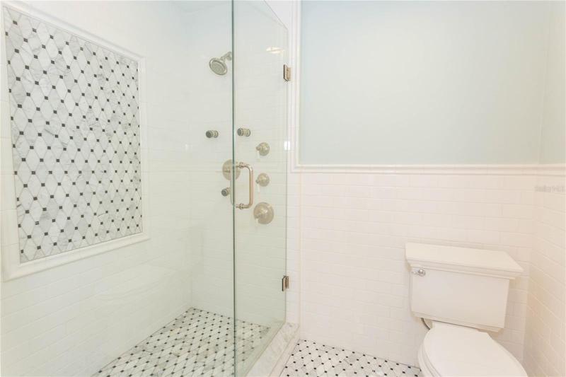 Main bathroom- spacious, "human car wash" glass shower with multiple heads.