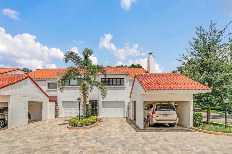 View of rear driveway & private 1-car garage.