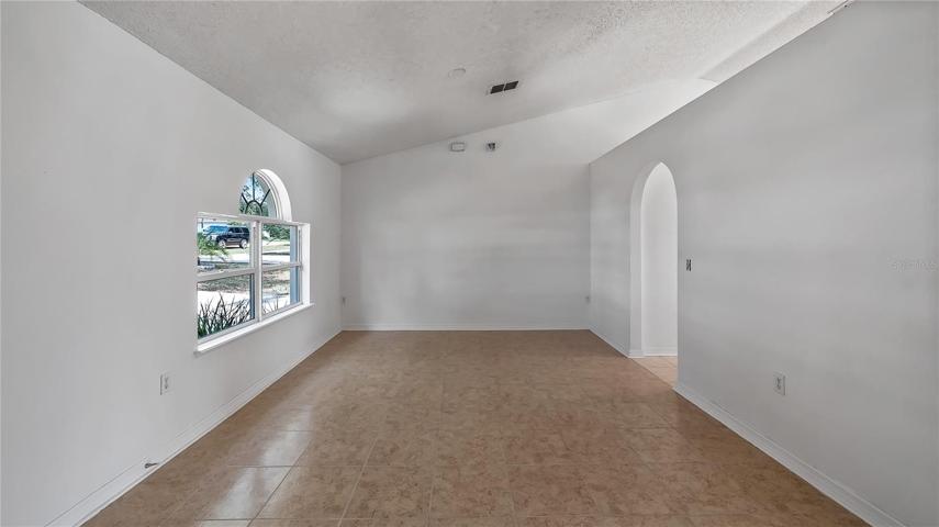 Right inside front door on the left. Formal dining room with new tile which could be office or bonus room