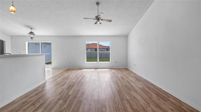 Great room with new flooring connected to kitchen & dinette
