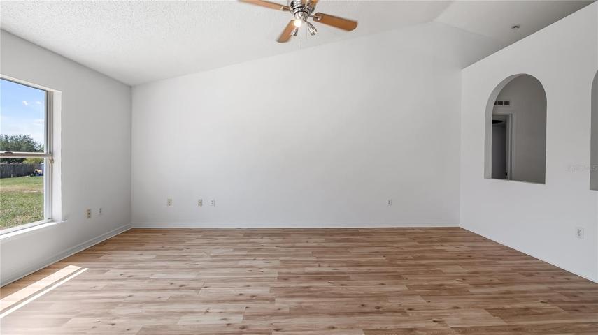 Great room with new flooring connected to kitchen