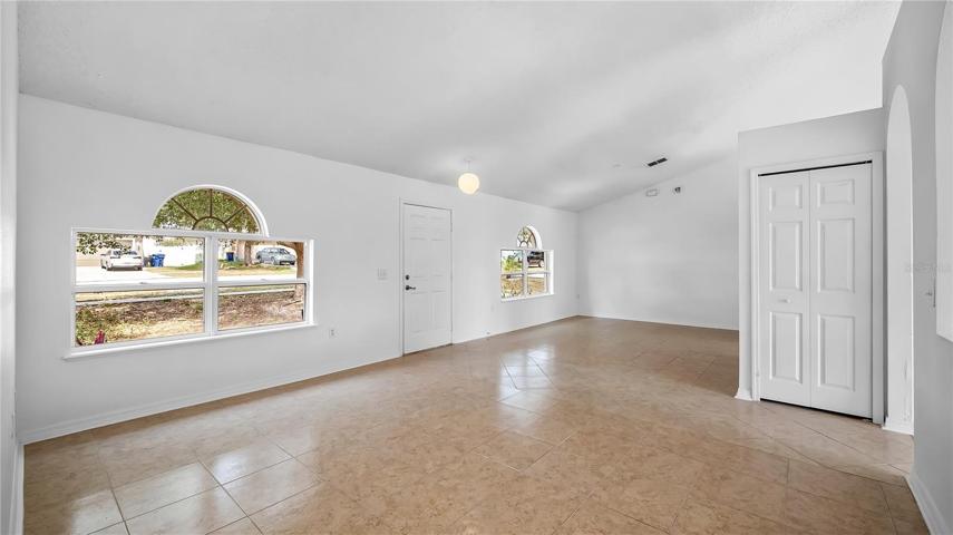 Large front room area right inside the front door that consists of the formal dining room and formal living room. ALL NEW TILE