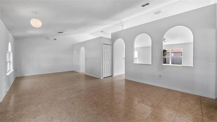 Right inside front door, large area that consists of Formal dining room off kitchen and formal living room on this side of the arches