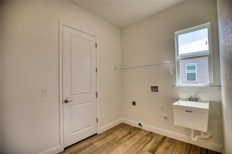 Expanded Laundry room with pocket door to kitchen/living area.