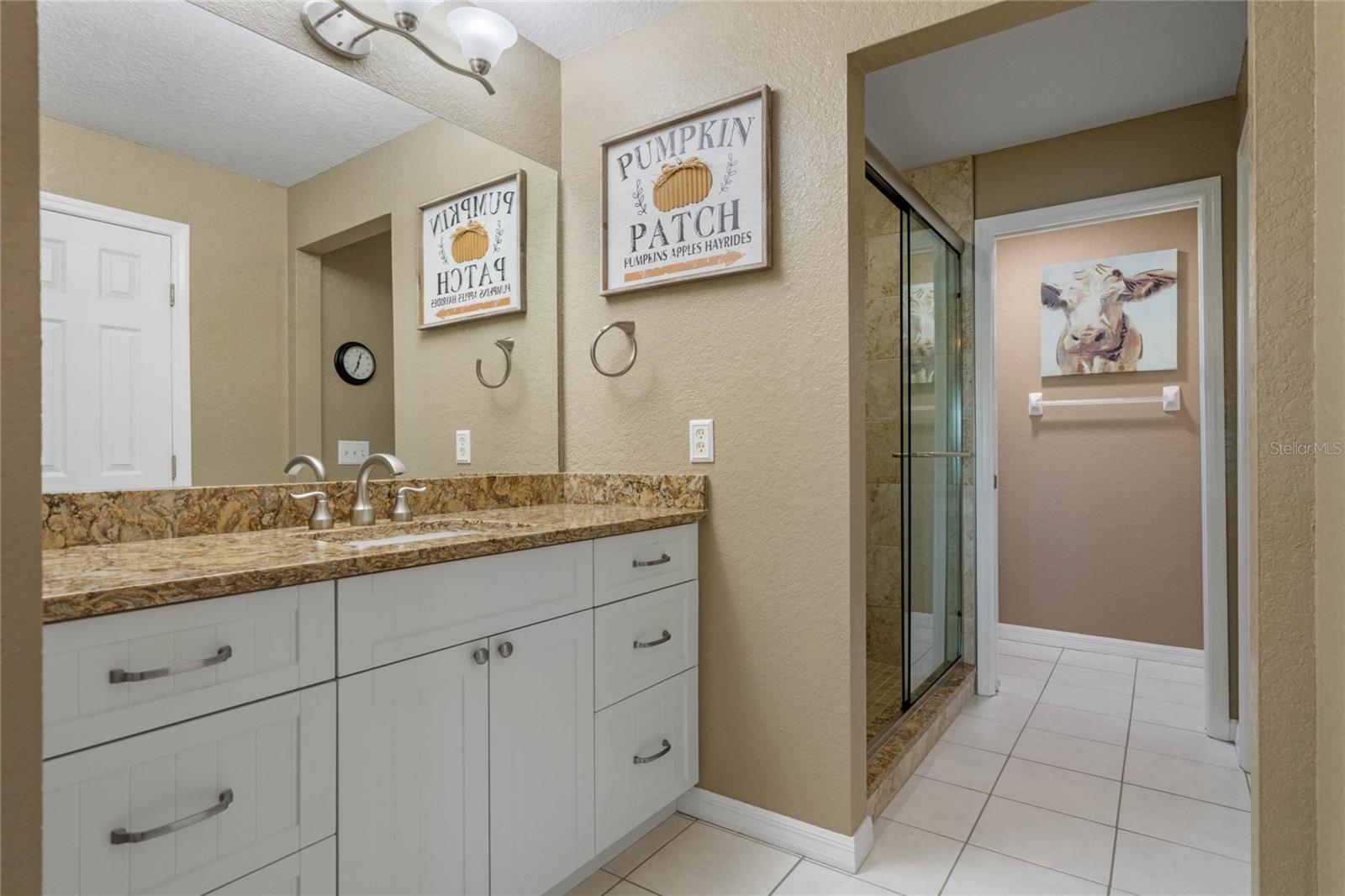 Comfort Height Vanity with Granite Countertop are located in the Master Bathroom