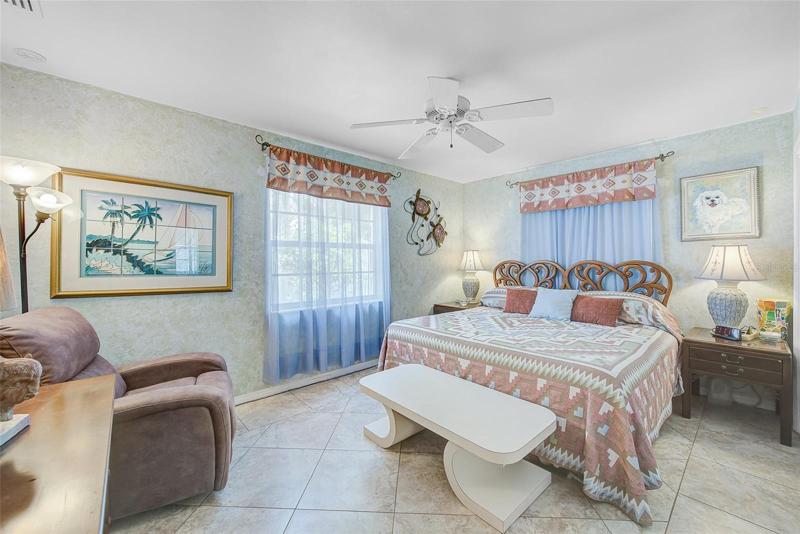 Guest bedroom with tile floors and double closets
