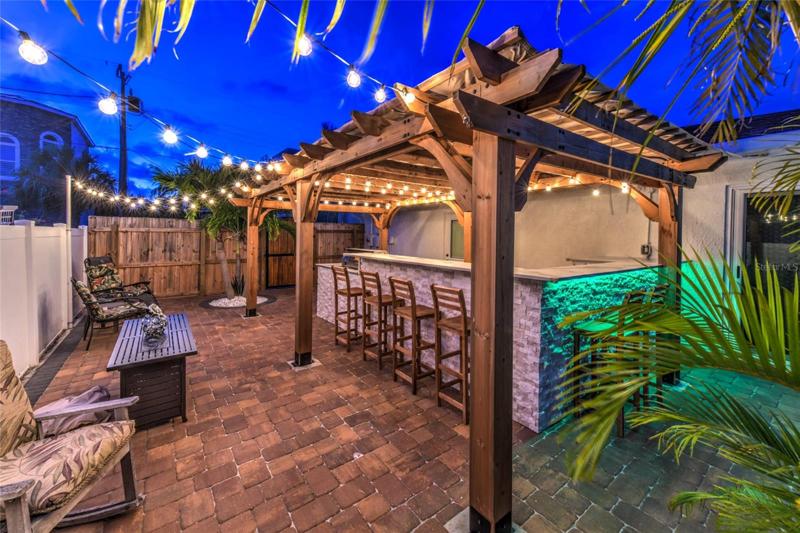 Paved outdoor kitchen with a firepit