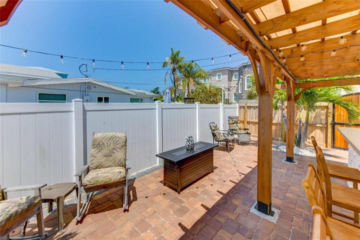 Fenced and paved outdoor kitchen