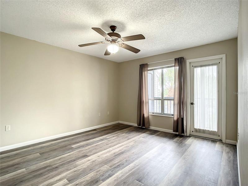 Primary bedroom with water view and access to screened in lanai.