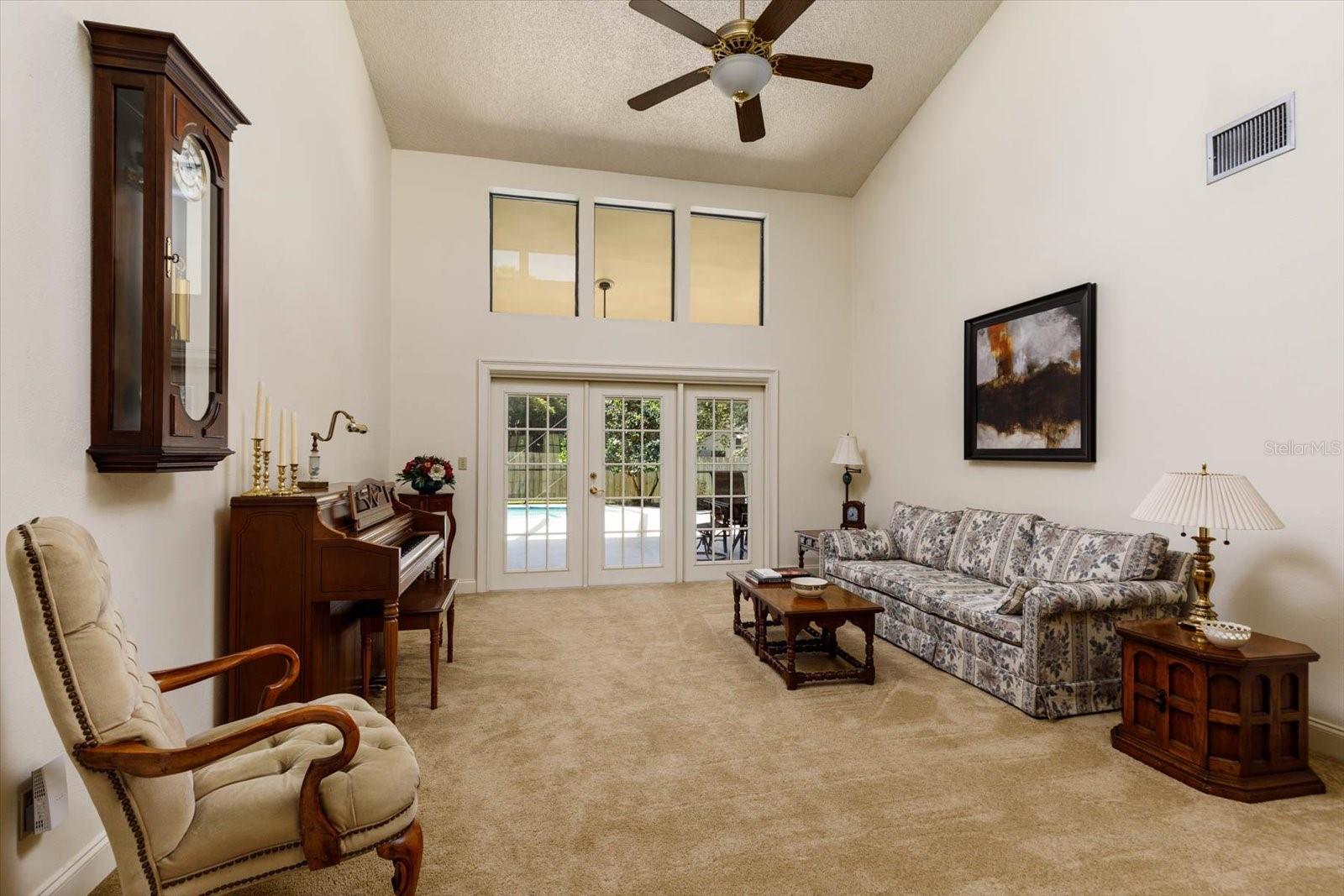 Formal Living Room with French doors to Lanai and pool deck.