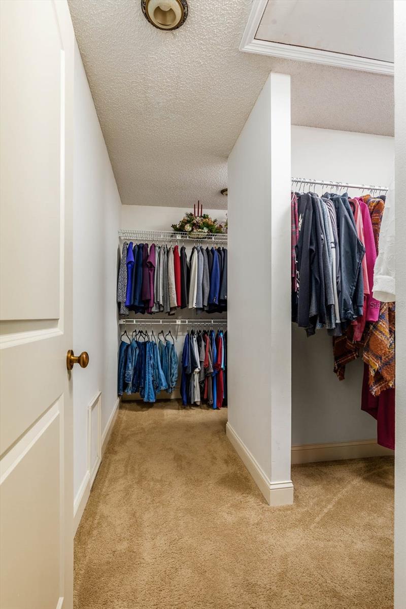 Huge walk in closet with His and Hers closet alcoves.