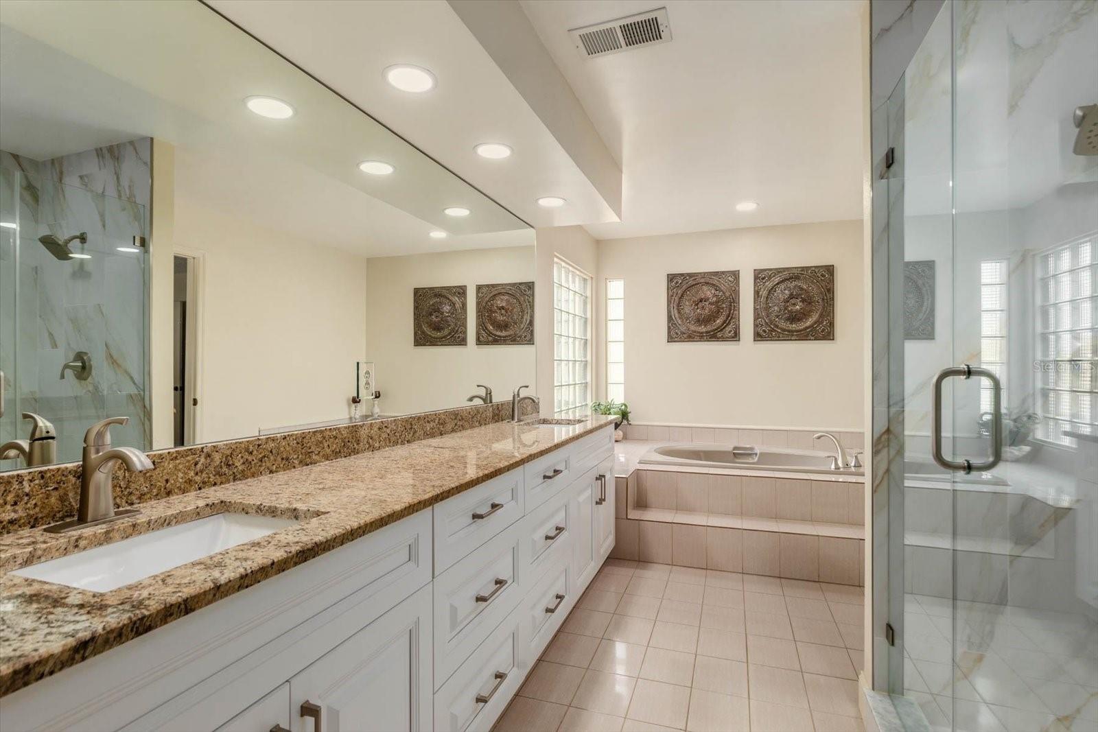 Primary Bath with two sinks, stand alone shower, and deep soak bath.