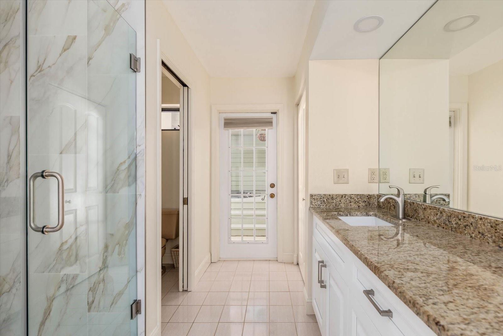 Primary Bath view toward outdoor spa access.