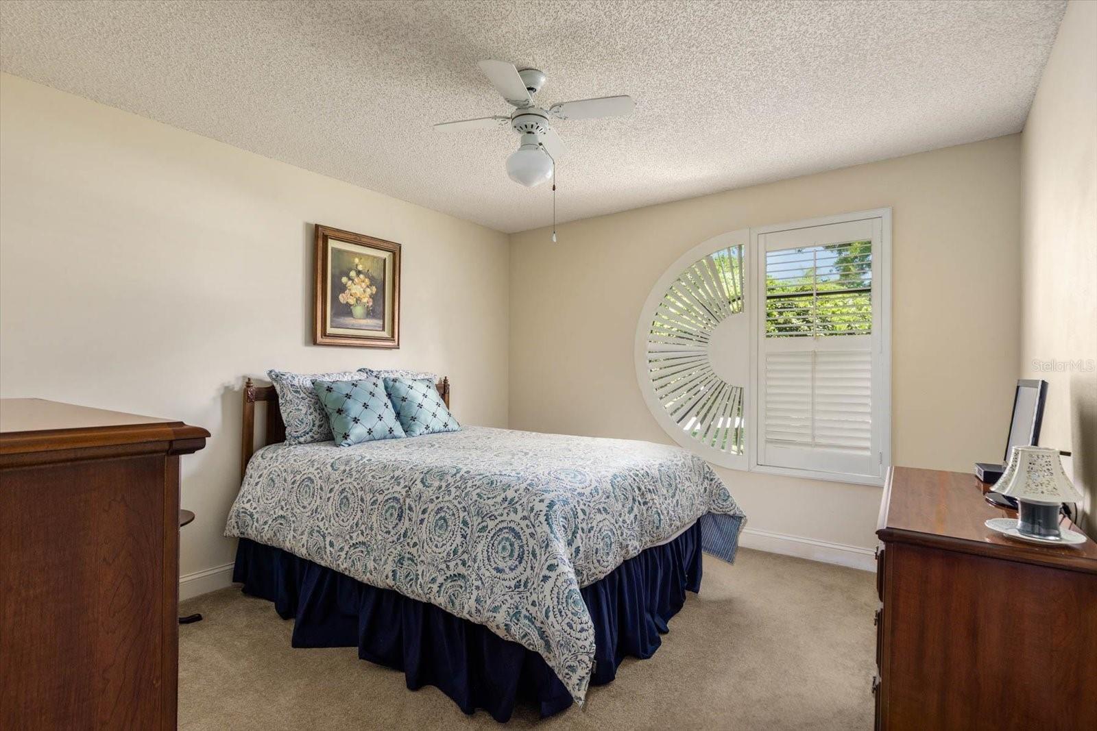 Bedroom 2 with designer window and custom shutters.