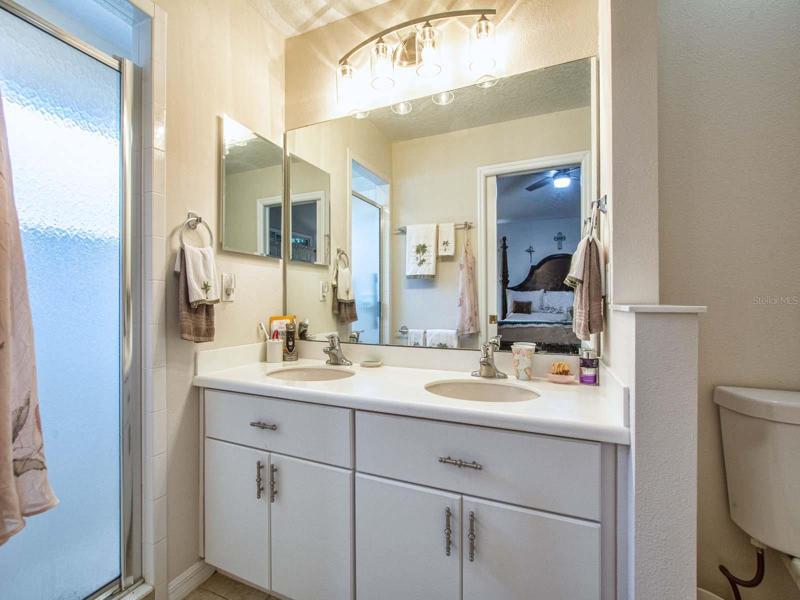Master bath, dual vanity and walk in shower with a light .