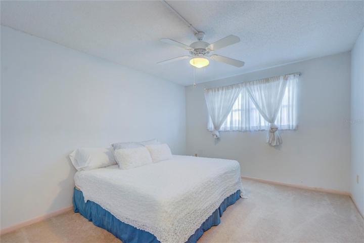 Guest Bedroom w large linear closets & ceiling fan.