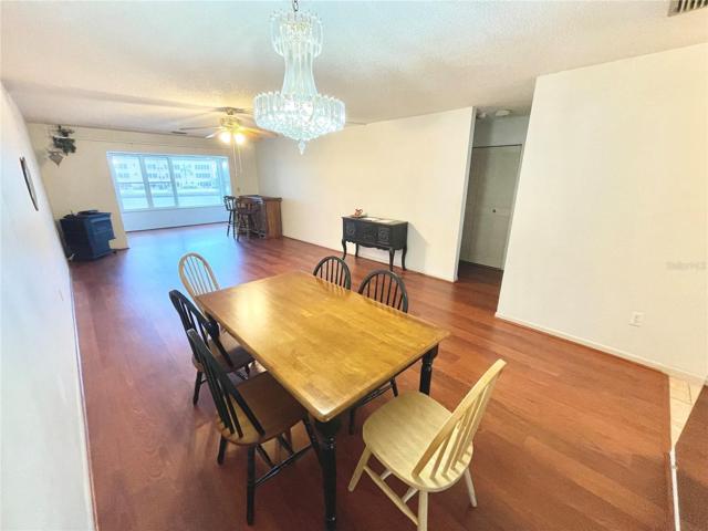 Spacious living area with water views and wood plank laminate flooring.