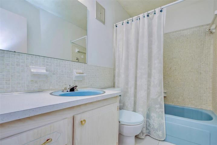 Guest bath withtub/shower combo & now has a new white toilet.