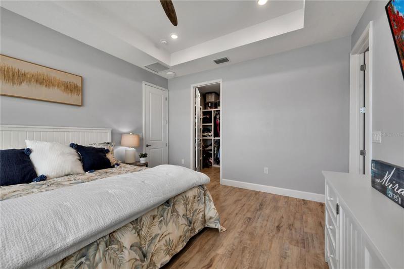 The large walk-in closet has an organizer in it.