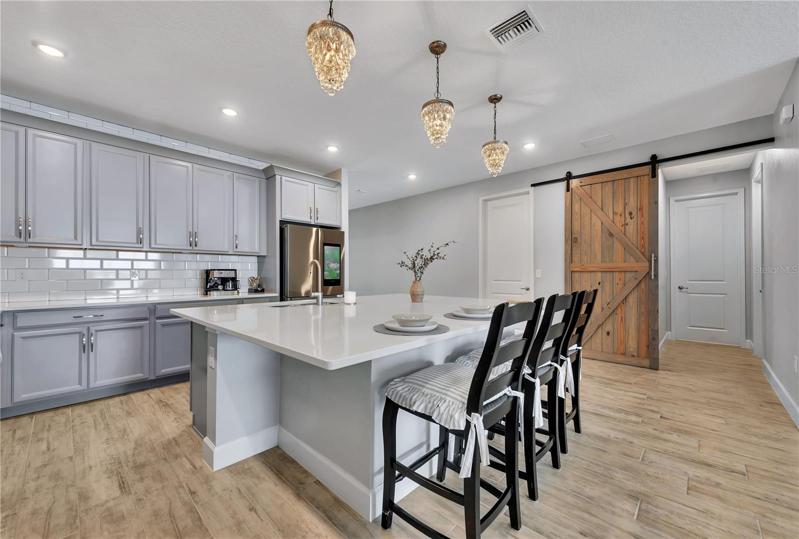 Notice the extended cabinets, built in microwave and wall oven, and did you notice the pendant lights over the breakfast bar?  The state-of-the-art refrigerator will really wow you.
