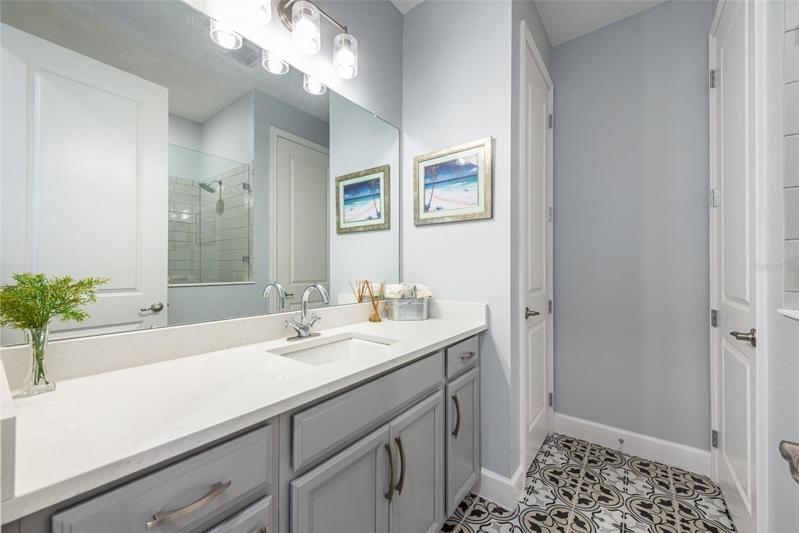 Bedroom 2 & 3 share this bathroom, notice the dual sinks in the Quartz countertop and the sliding door on the bath/shower.
